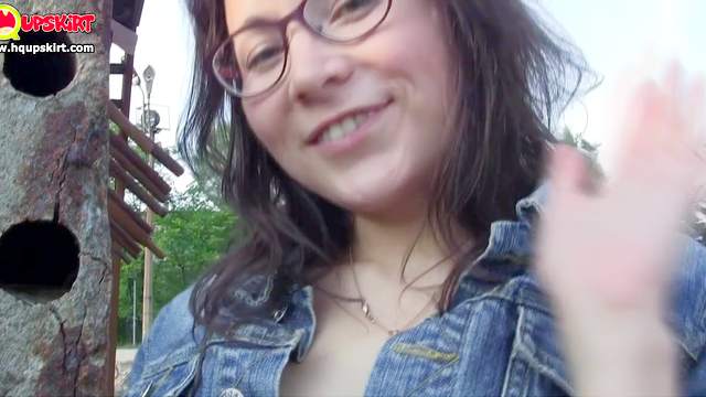 Brunette in glasses makes an upskirt outdoors