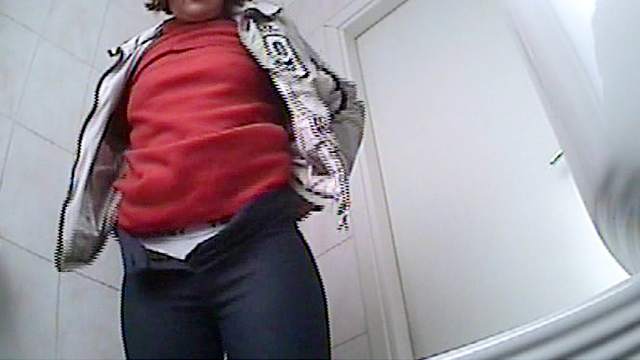 Busty beauty is taking off her panties while pissing in the voyeur clip