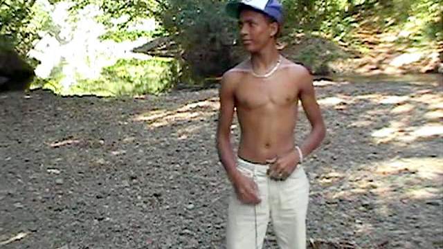 Black gay is masturbating his dick outdoors