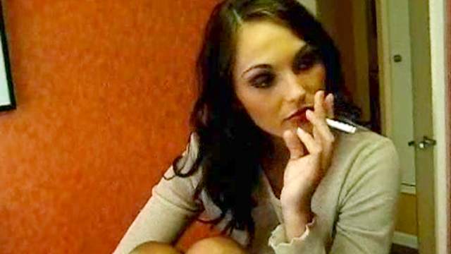 Brunette has cigarette in front of a mirror