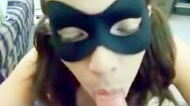 Brunette teen wearing a mask sucks this guys ball and dick