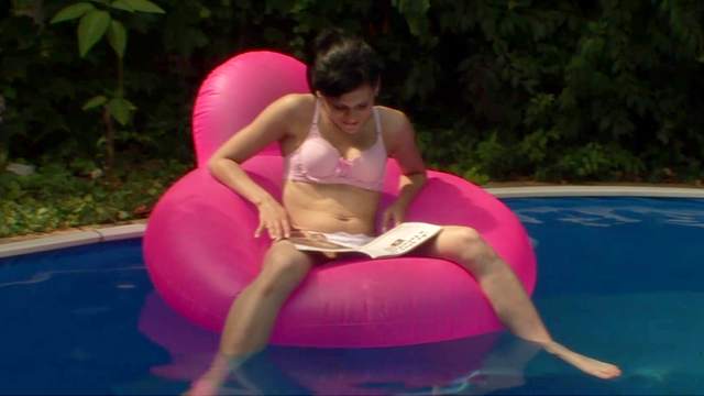 Skinny teen is masturbating in the pool