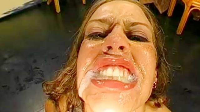 cock-swallowing lady smiles during bukkake