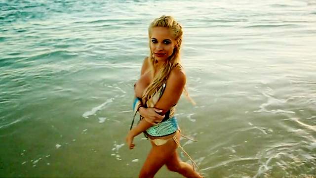 Buxom blonde bombshell Dani Mathers poses on the beach