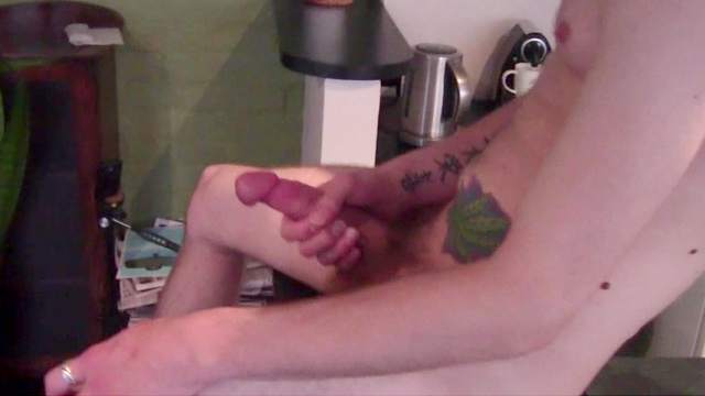 Tattooed guy jerks off her nice dick at the kitchen