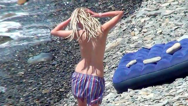 Hardcore blonde is getting naked on the beach