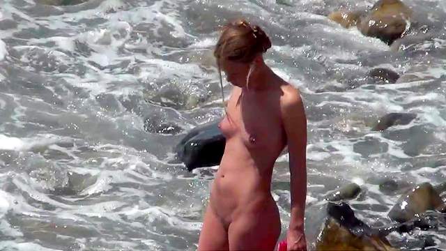 Amateur blonde is getting naked on the beach
