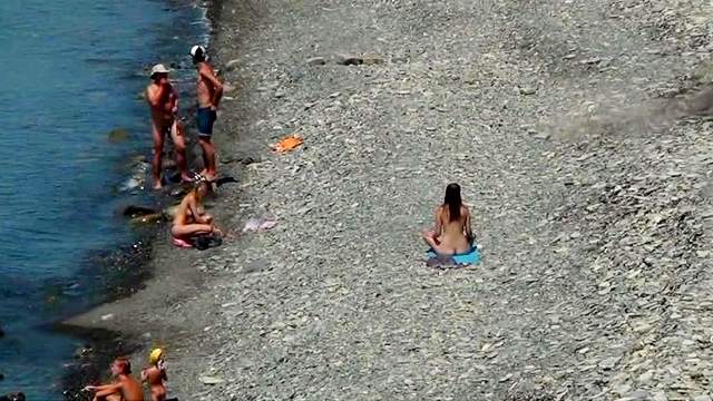 Sexy chicks are walking undressed on the beach