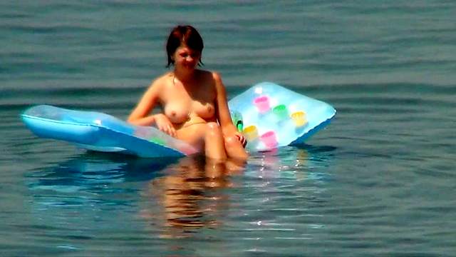 Sexy nudists are walking in the sea