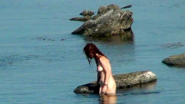 Sweet skinny babe is walking on the beach