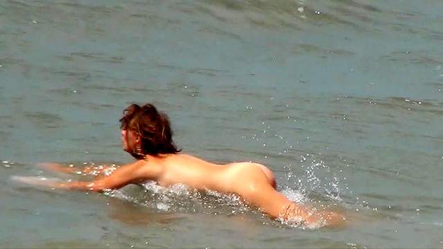 Sweetie is lying naked on the beach