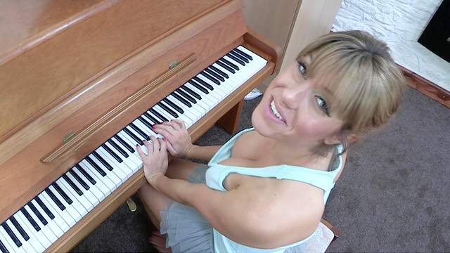 Sexy blonde Talia is playing on piano