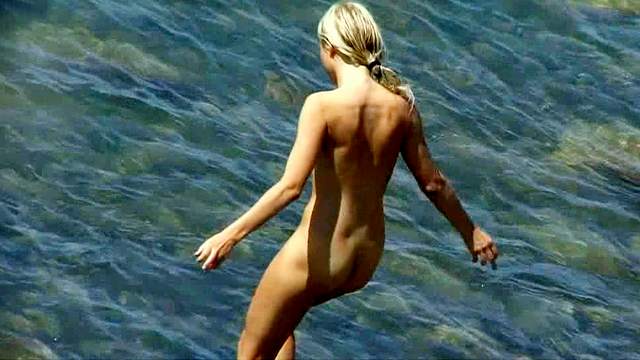Skinny blonde is walking naked in the sea!