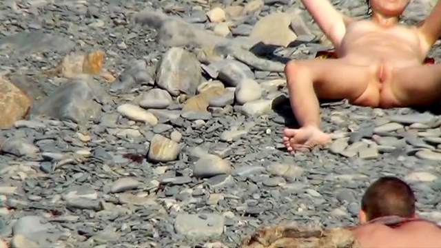 Nudist chick is getting naked on the beach