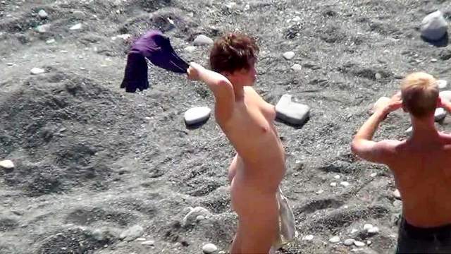 Sexy nudist is getting naked on the beach
