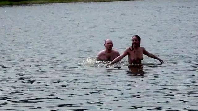 Sexy couple is posing naked in the river