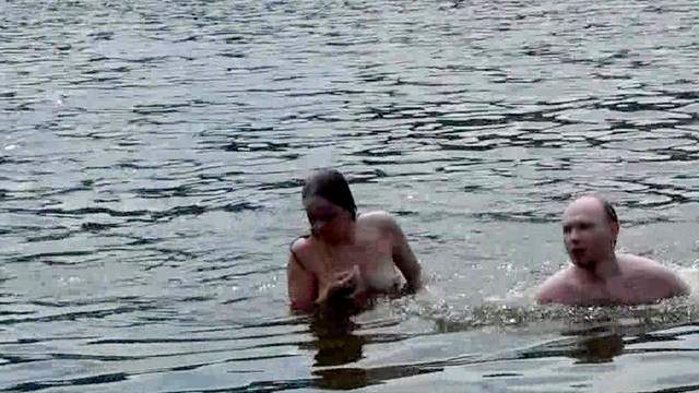 Sexy couple is posing naked in the river
