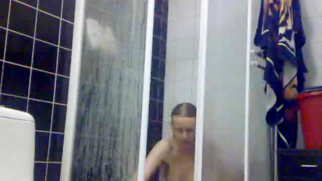 Voyeur view of showering girl