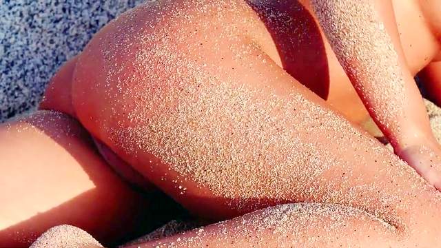 Tahlia Paris rubs her naked body by trhe warm sand