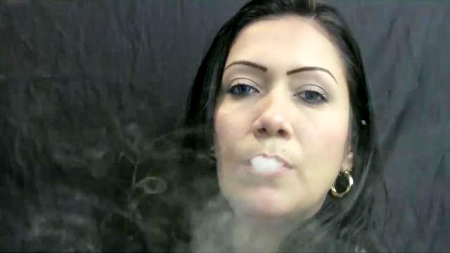 Latina blowing smoke sensually