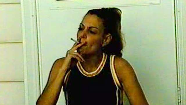 Astounding brunette is smoking her last cigarette in the room