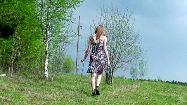 Cute girl in a dress pisses outdoors