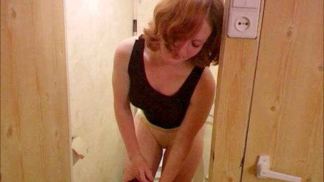 Cute girl goes pee in the toilet