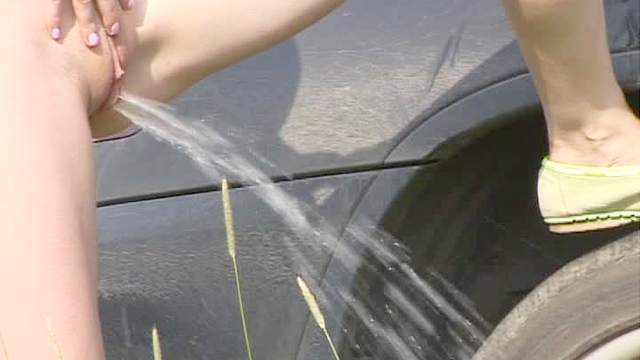 Skinny redhead pees in the grass