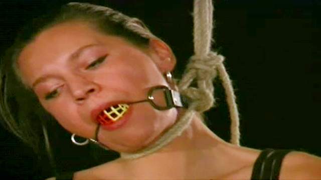 Gagged and tied girl in dungeon