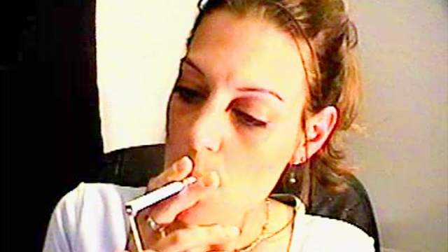 She smokes close up on webcam