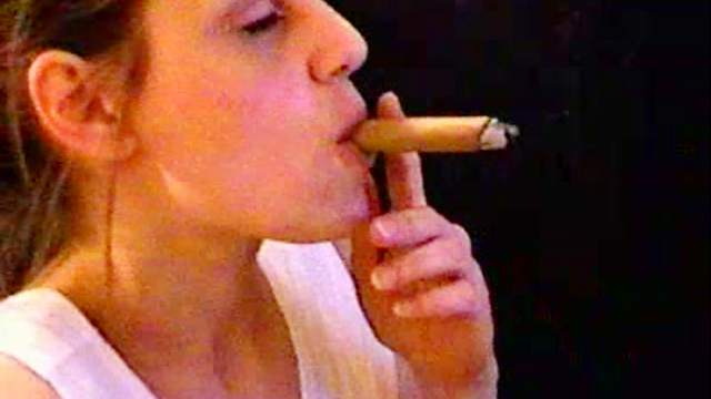 Cute babes smokes a cigar and poses on camera