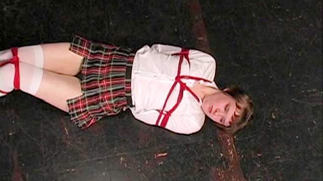 Schoolgirl bound by red ropes
