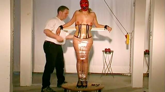 Tight rubber corset on his BDSM girl