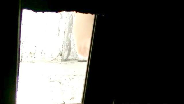 Voyeur pissing in an outhouse
