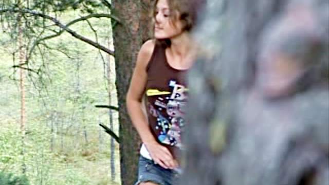 Girl in sneakers pees in the woods