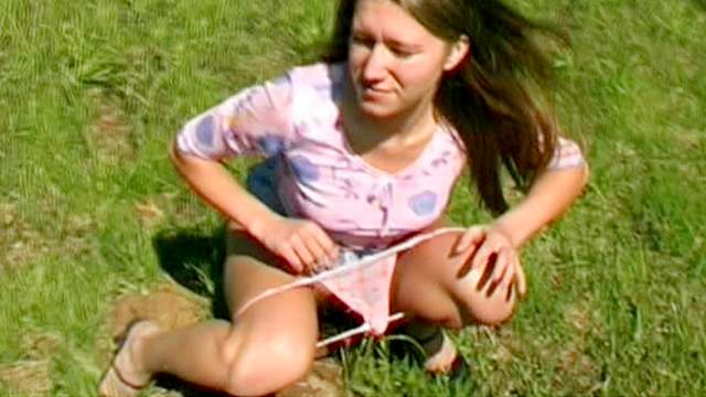 Pissing pussy in a wide open grassy field