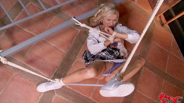 Schoolgirl struggles against the rope bondage