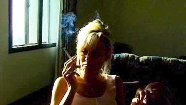 Blonde smokes and shows us her big tits