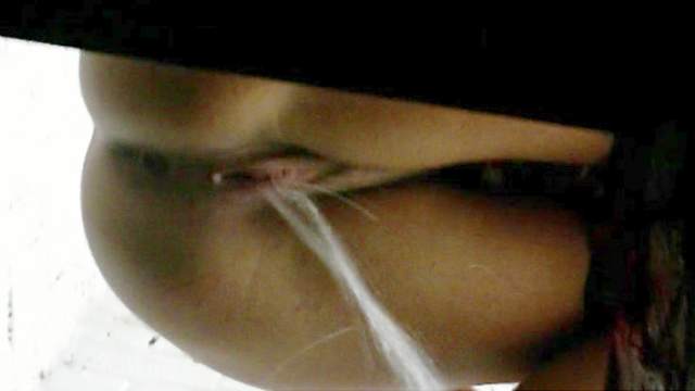 Chick pisses in a hole in voyeur flick