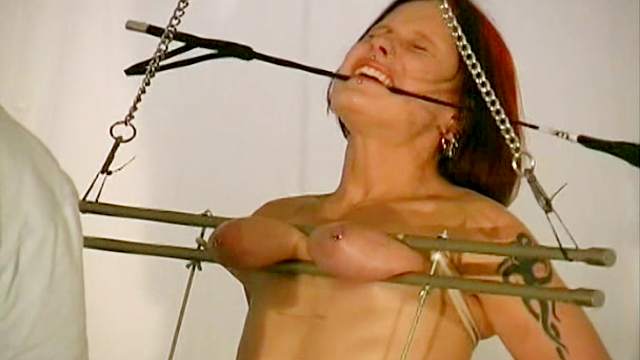 Hot redhead with tied hands and tits torture