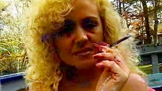 Curly blonde is smoking in a sexy hot way