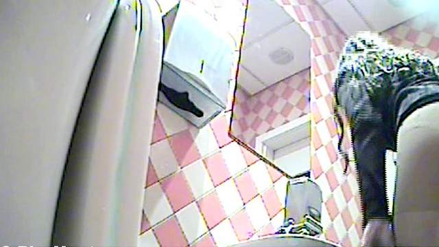 Busty blonde is peeing in the toilet