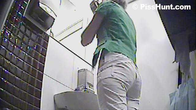 Alluring babe is pissing in the toilet