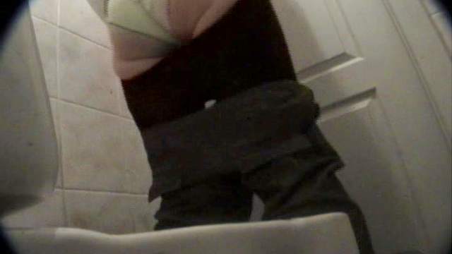 Hardcore beauty with cute face is pissing in the toilet