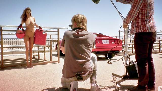 Alyssa Arcè is posing on a classic old Ferrari