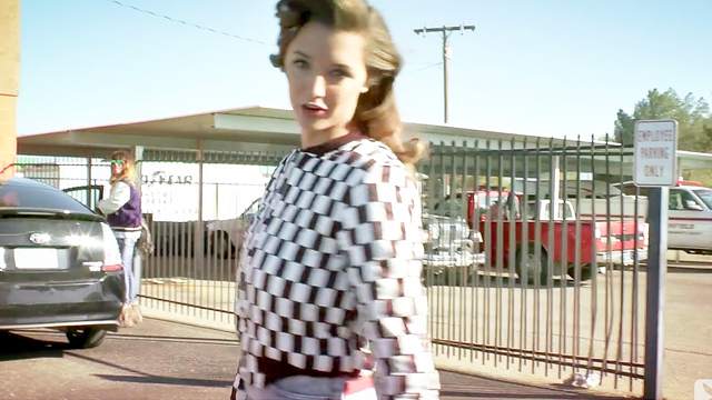 Alyssa Arcè is posing on a classic old Ferrari