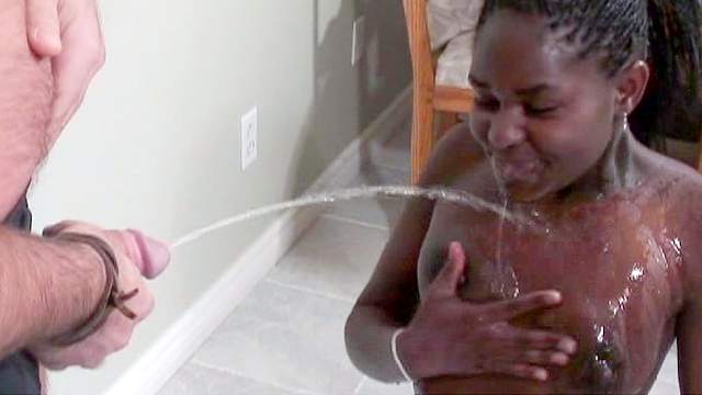 Alluring ebony with a nice face gets a flow of urine
