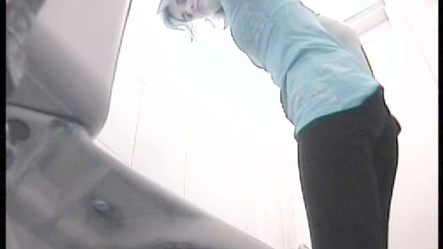 Innocent slender cutie is pissing in the toilet